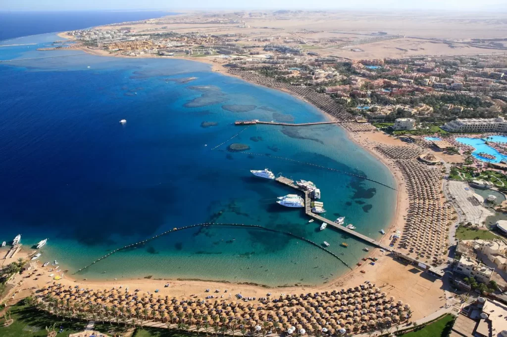 Snorkeler over a vibrant house reef with hotel deals in Makadi Bay